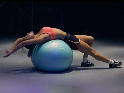 Woman stretching over exercise ball