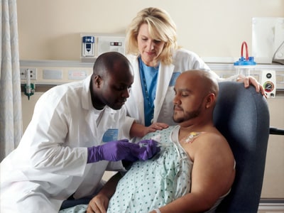 Patient being looked at by two doctors